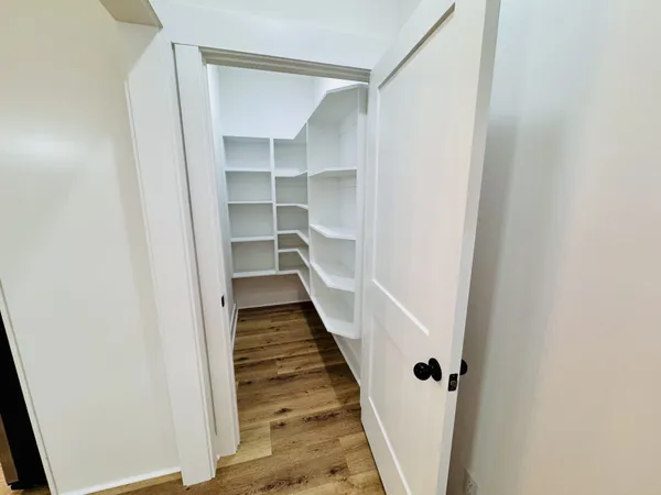 a view of empty room with wooden floor