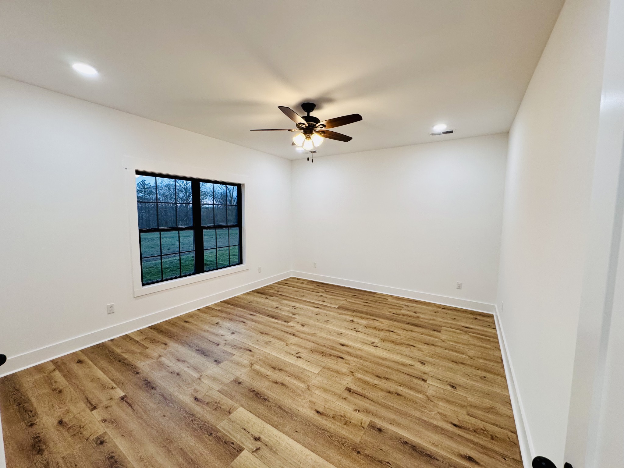 62 Hall Street Lexington, TN 38351 - Photo 33 of 48 wooden floor in an empty room with a window