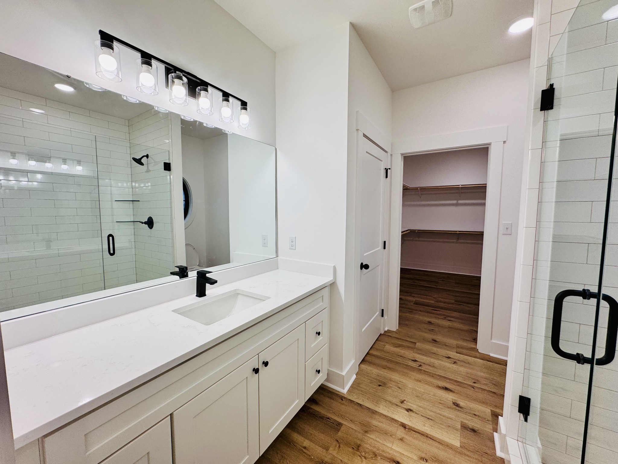 62 Hall Street Lexington, TN 38351 - Photo 35 of 48 a spacious bathroom with a double vanity sink a large mirror and shower