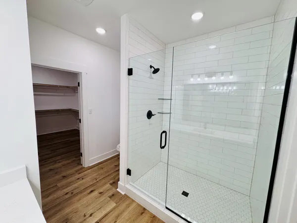 a bathroom with a shower and a mirror