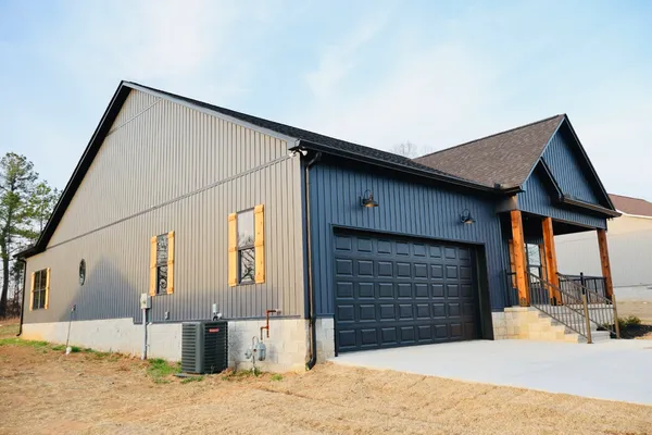 a view of a house with wooden fence in front of house