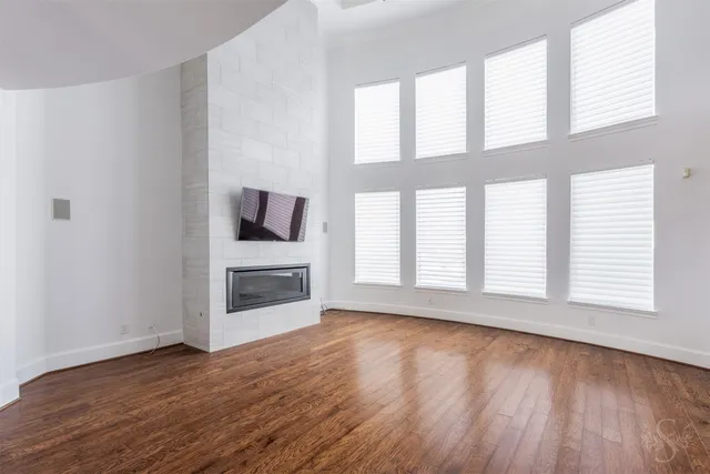 a kitchen with kitchen island granite countertop a stove a sink and a microwave