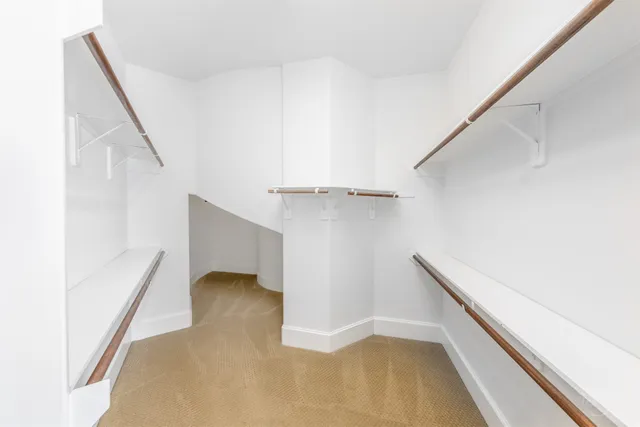 a view of a hallway with chandelier