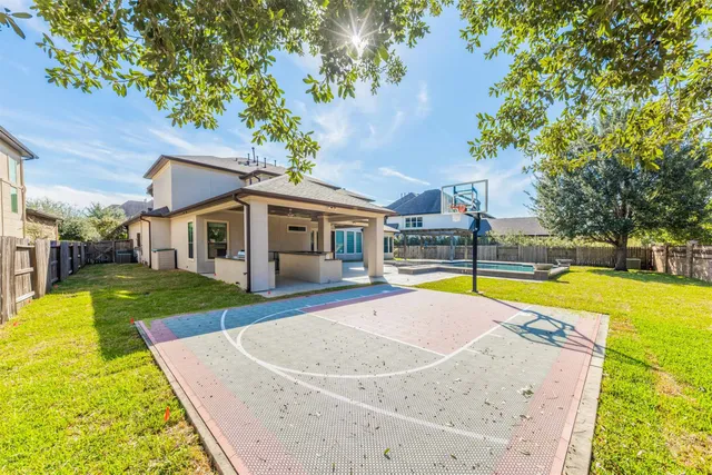 a view of a house with a yard and tree s