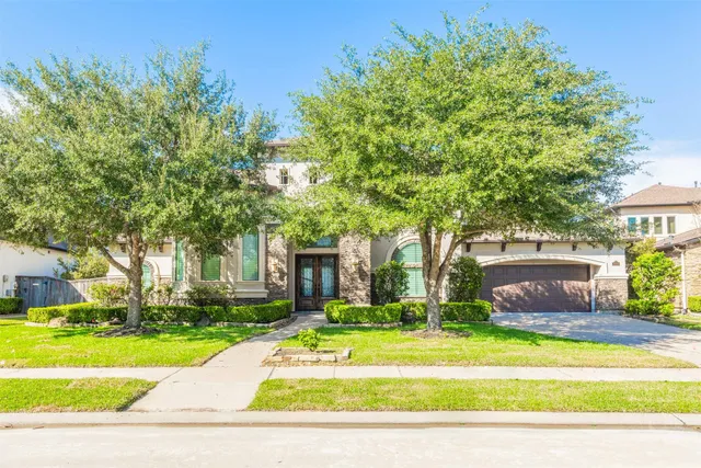 a view of a house with swimming pool and a yard