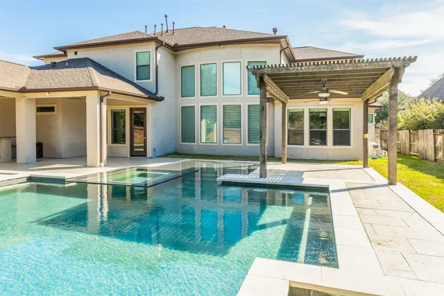 a front view of a house with garden and garage