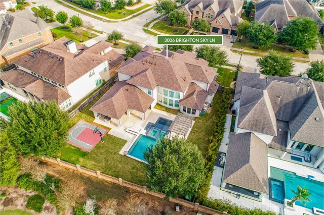 an aerial view of residential house with outdoor space and pool