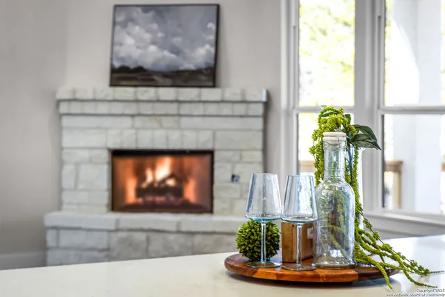 a living room with a fireplace and a flat screen tv