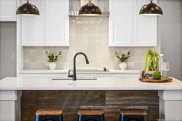 a close view of a sink a counter and appliances in a kitchen