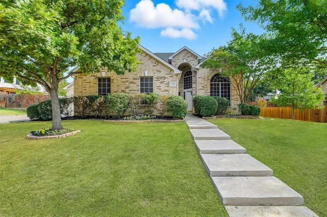 a front view of a house with yard and green space