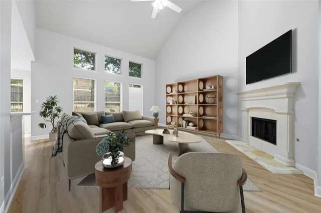 a living room with furniture a flat screen tv and a fireplace