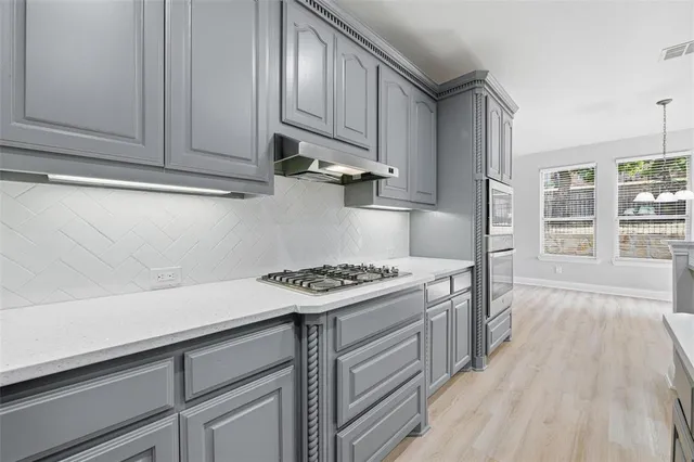 a kitchen with a stove and a refrigerator