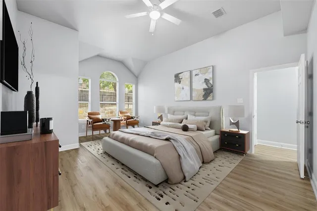 a bedroom with a balcony a bed and a flat screen tv