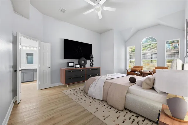 a bedroom with furniture and a flat screen tv