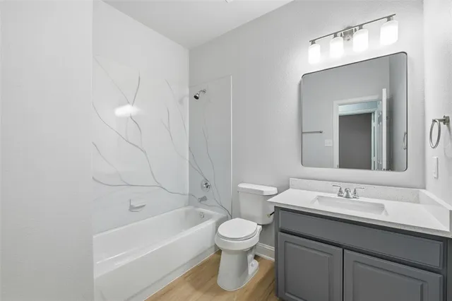 a bathroom with a toilet a sink a mirror and bathtub