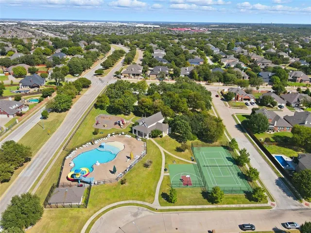 an aerial view of a house with a swimming pool