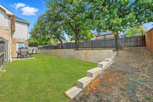 a view of a backyard with a garden and plants