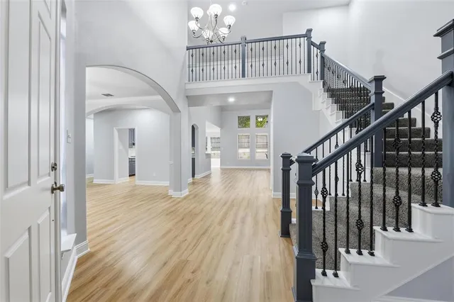 a view of entryway and hall with wooden floor