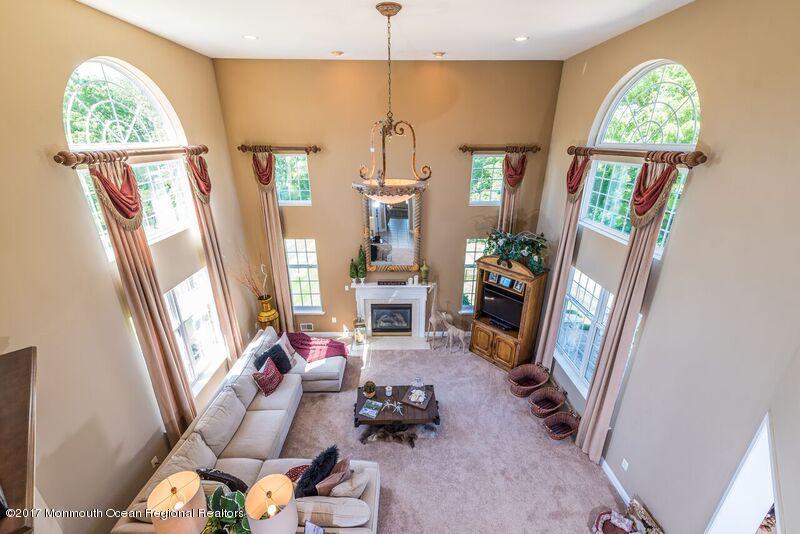 8 Rodeo Drive Jackson, NJ 08527 - Photo 13 of 54 a living room with furniture and a chandelier