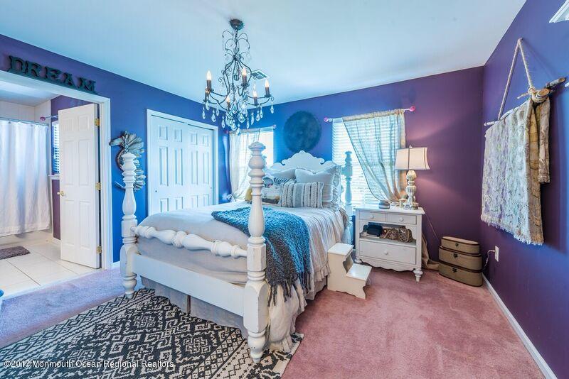 8 Rodeo Drive Jackson, NJ 08527 - Photo 21 of 54 a bed room with a bed and a chandelier