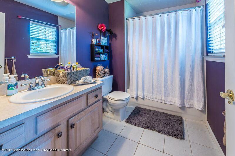 8 Rodeo Drive Jackson, NJ 08527 - Photo 22 of 54 a bathroom with a sink a toilet and shower curtain