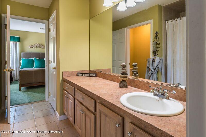 8 Rodeo Drive Jackson, NJ 08527 - Photo 25 of 54 a bathroom with a double vanity sink and a mirror