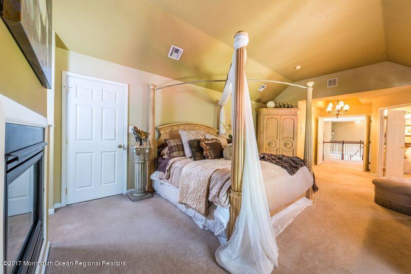 8 Rodeo Drive Jackson, NJ 08527 - Photo 27 of 54 a bed room with a bed and a chandelier