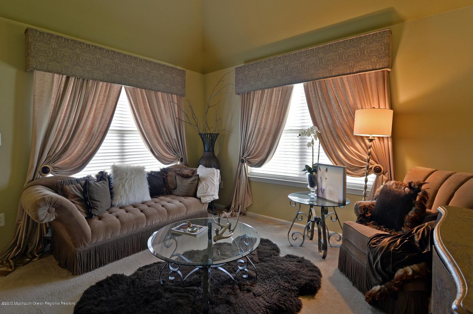 8 Rodeo Drive Jackson, NJ 08527 - Photo 28 of 54 a living room with furniture a fireplace and large windows