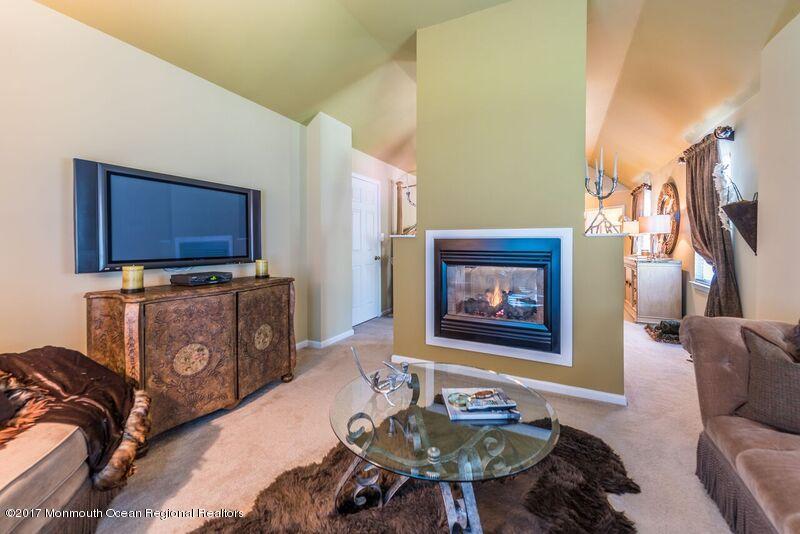 8 Rodeo Drive Jackson, NJ 08527 - Photo 29 of 54 a living room with furniture and a flat screen tv