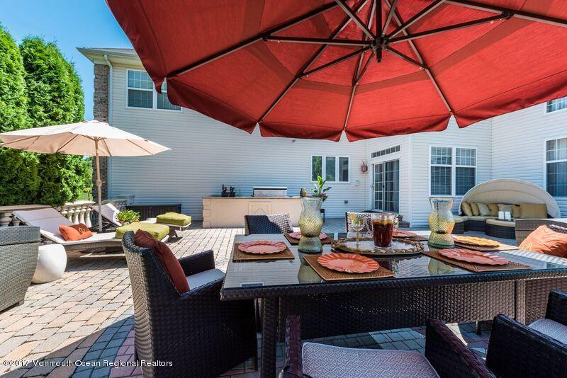 8 Rodeo Drive Jackson, NJ 08527 - Photo 39 of 54 a patio with a table and chairs under an umbrella