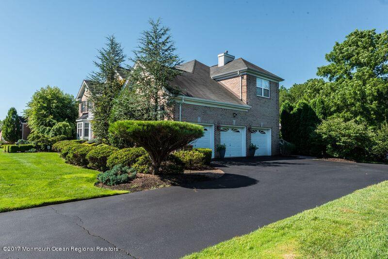 8 Rodeo Drive Jackson, NJ 08527 - Photo 4 of 54 a front view of a house with a garden and yard