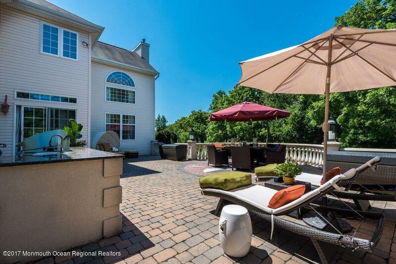 8 Rodeo Drive Jackson, NJ 08527 - Photo 41 of 54 a view of patio with chairs and table under an umbrella