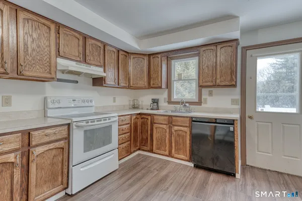 an empty room with wooden floor and a window