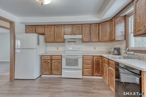 a kitchen with a refrigerator stove and sink