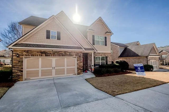 a front view of a house with a yard and garage