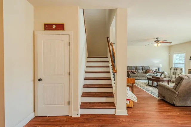 a view of a living room with furniture and wooden floor