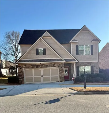 a front view of a house with a yard and garage