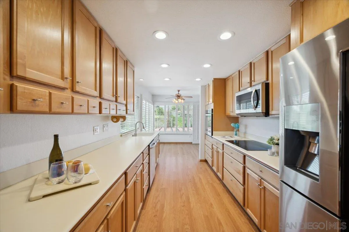 3316 Del Charro Road Jamul, CA 91935 - Photo 5 of 45 a kitchen with stainless steel appliances a sink stove and cabinets