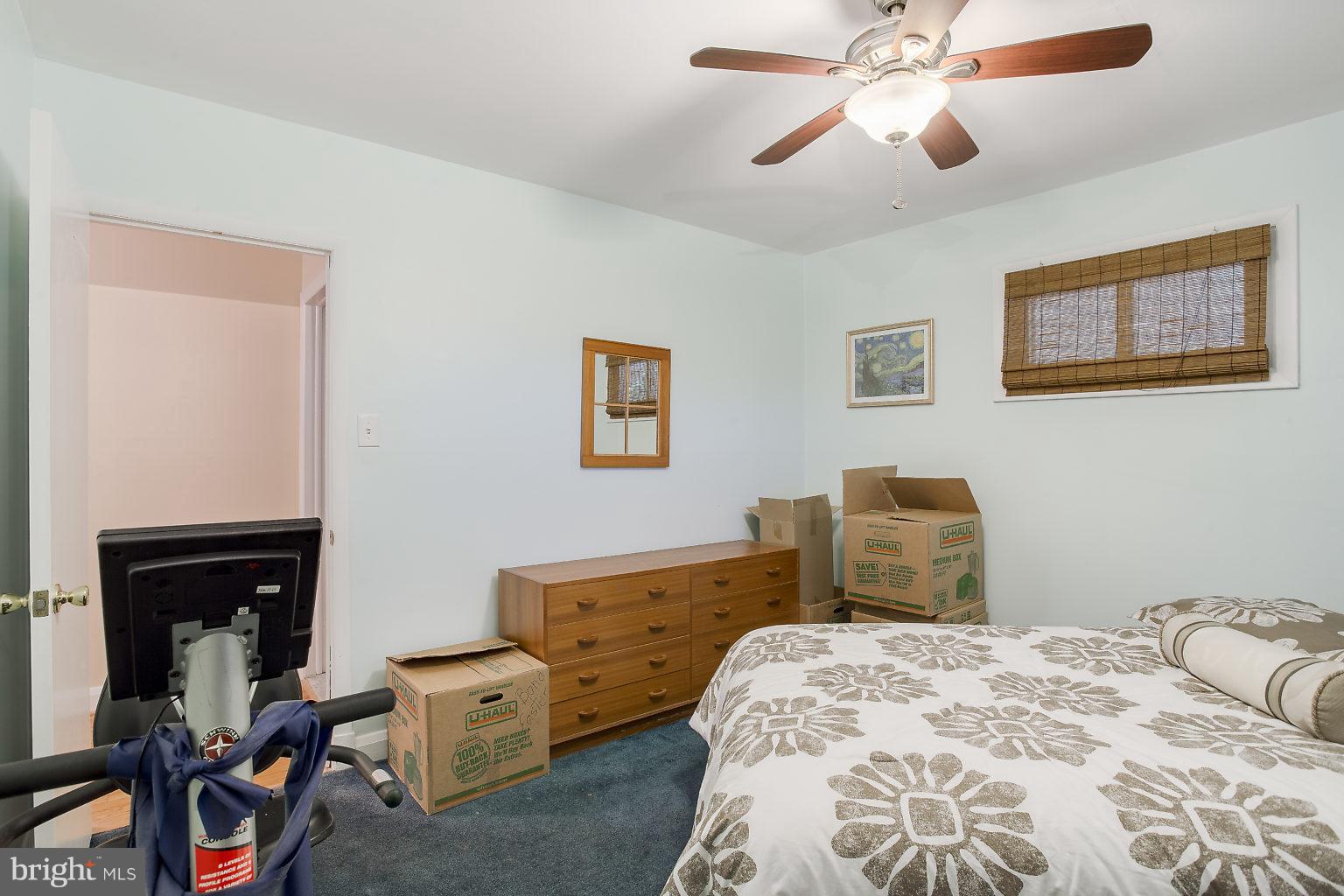 8414 Dogwood Road Baltimore, MD 21244 - Photo 11 of 29 a bedroom with a bed and wooden floor