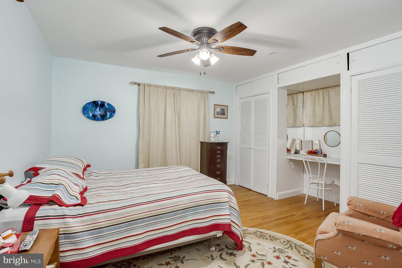 8414 Dogwood Road Baltimore, MD 21244 - Photo 12 of 29 a bedroom that has a bed and a table in it