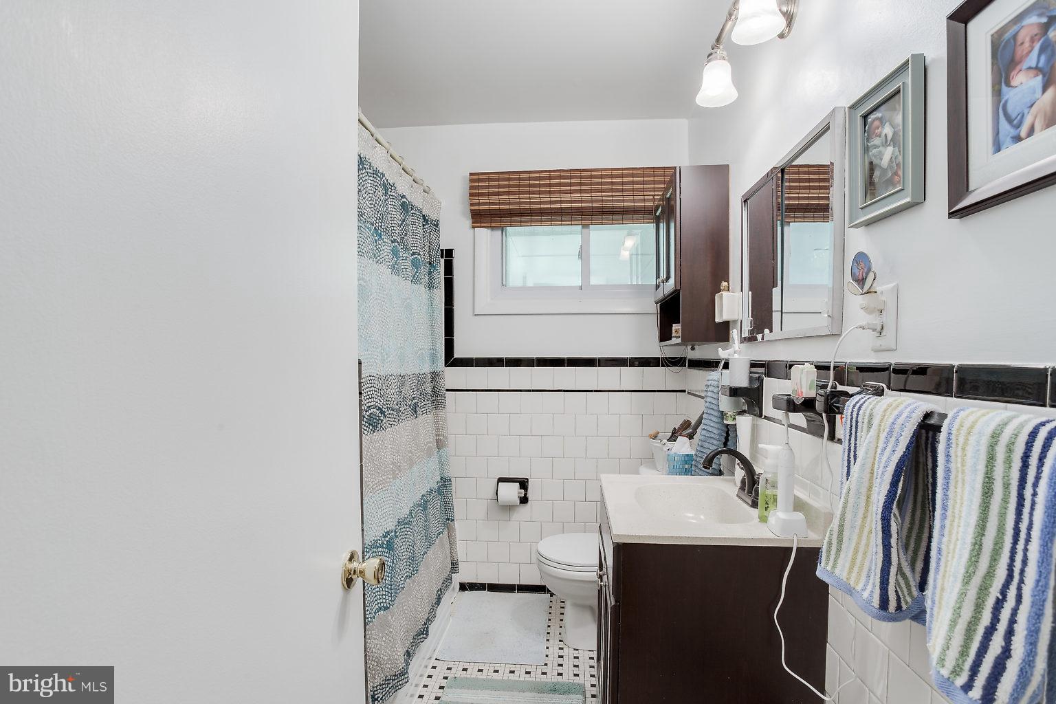8414 Dogwood Road Baltimore, MD 21244 - Photo 14 of 29 a bathroom with a sink a toilet and shower