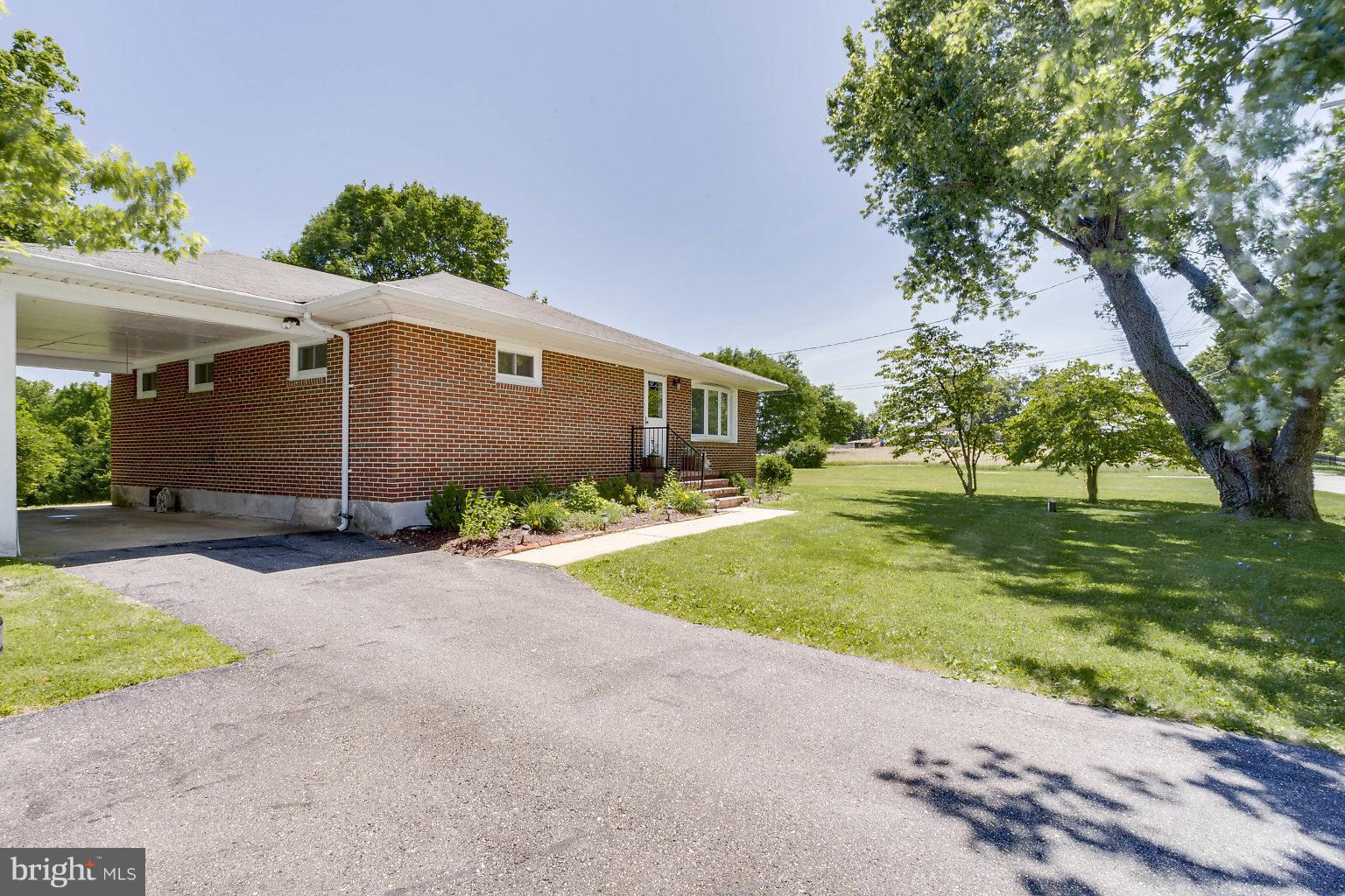8414 Dogwood Road Baltimore, MD 21244 - Photo 3 of 29 a front view of a house with garden