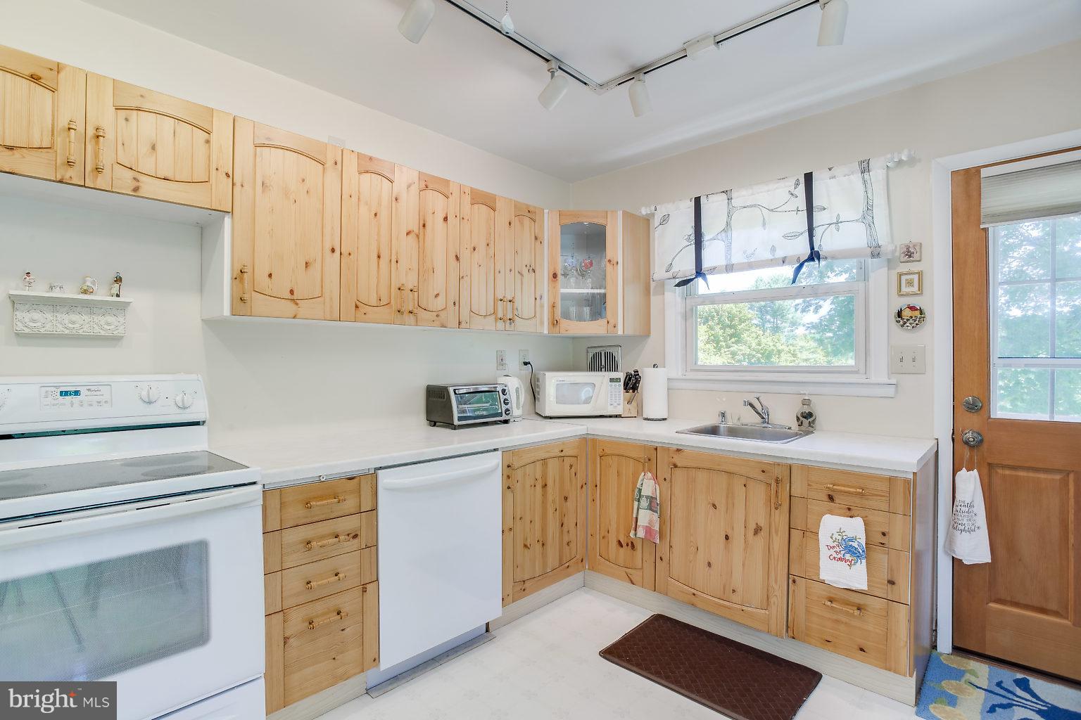 8414 Dogwood Road Baltimore, MD 21244 - Photo 21 of 29 a kitchen with cabinets appliances a sink and a window