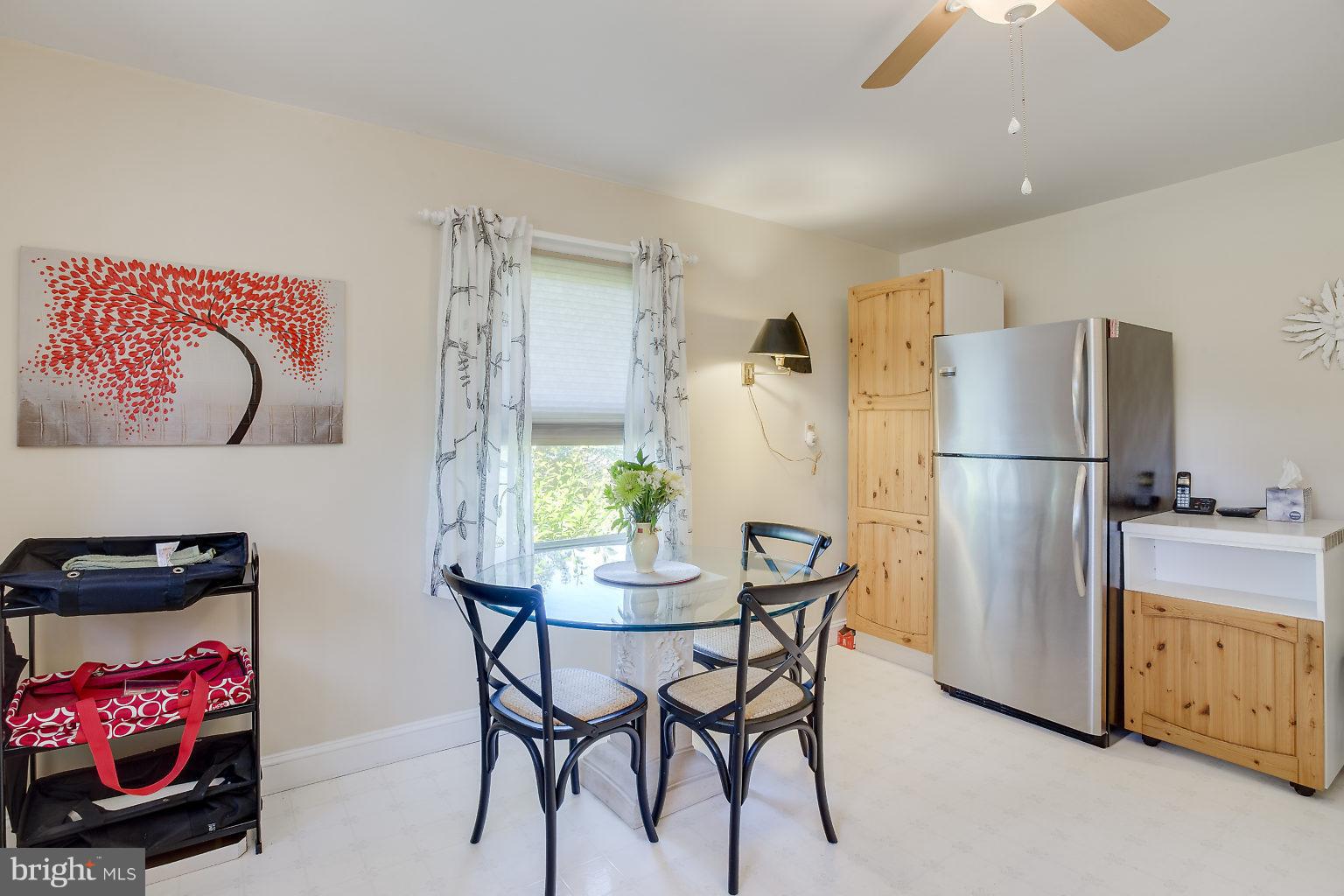 8414 Dogwood Road Baltimore, MD 21244 - Photo 22 of 29 a kitchen with stainless steel appliances granite countertop a refrigerator and a dining table