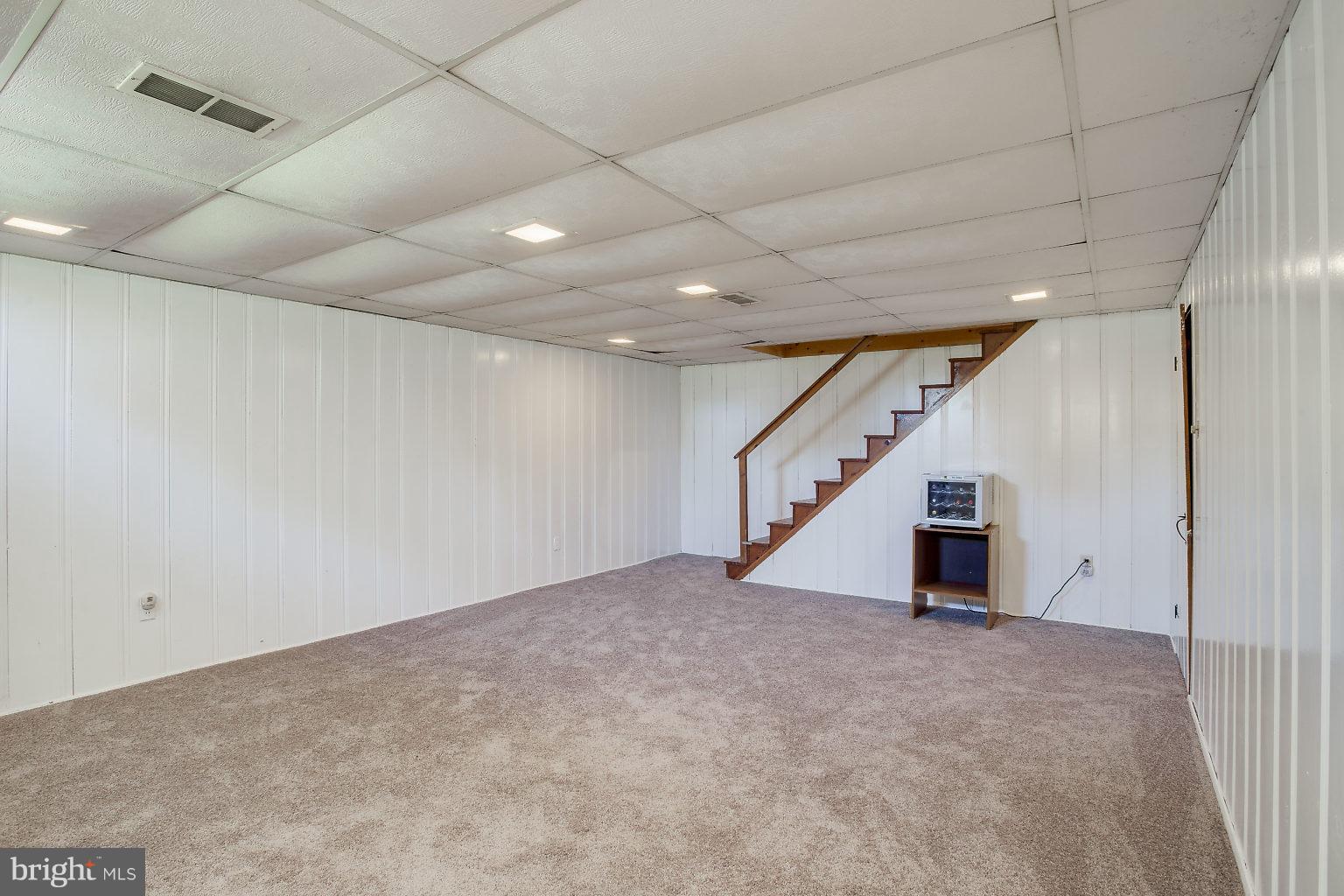8414 Dogwood Road Baltimore, MD 21244 - Photo 24 of 29 an empty room with windows and stairs