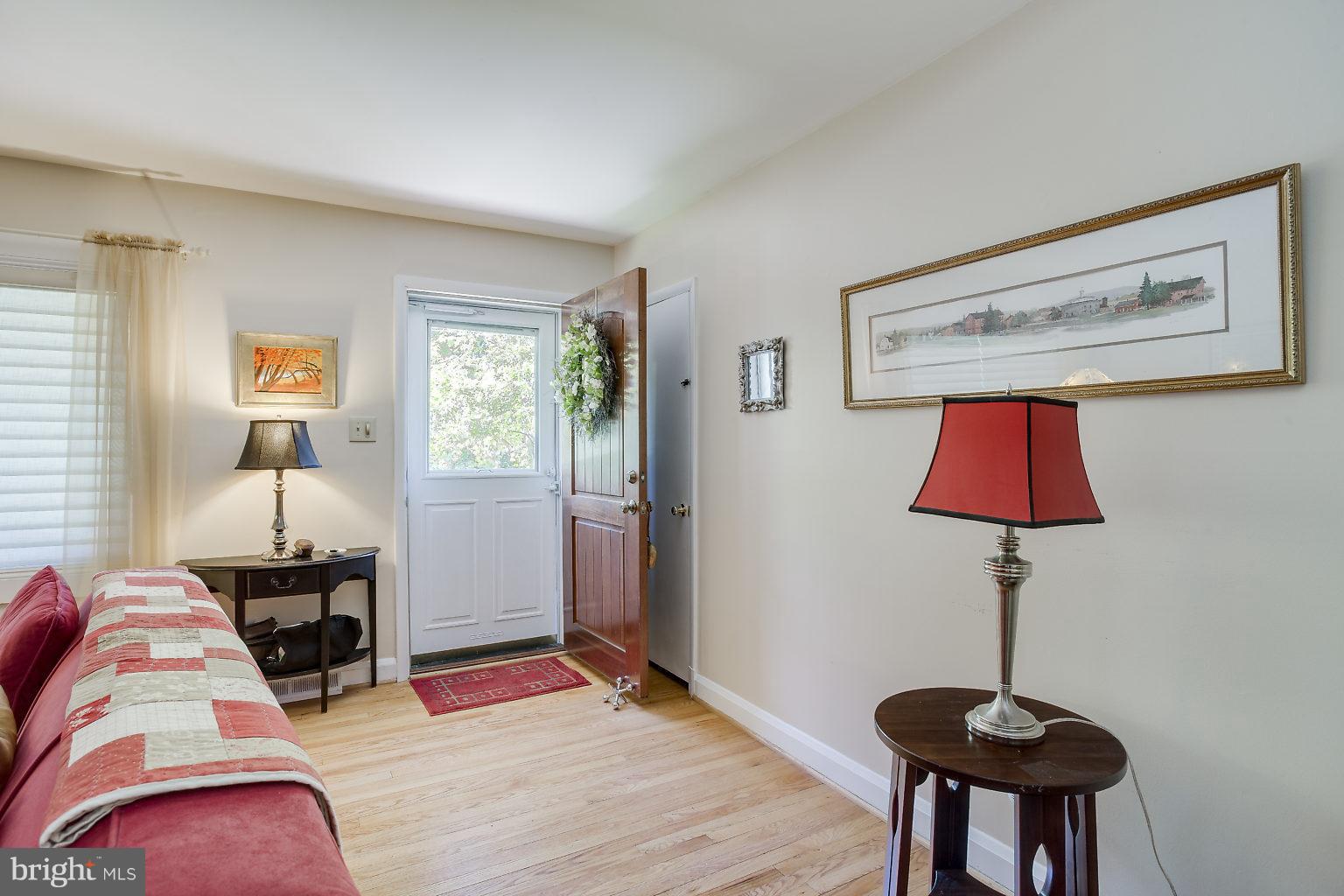 8414 Dogwood Road Baltimore, MD 21244 - Photo 4 of 29 a bedroom with a bed and a lamp