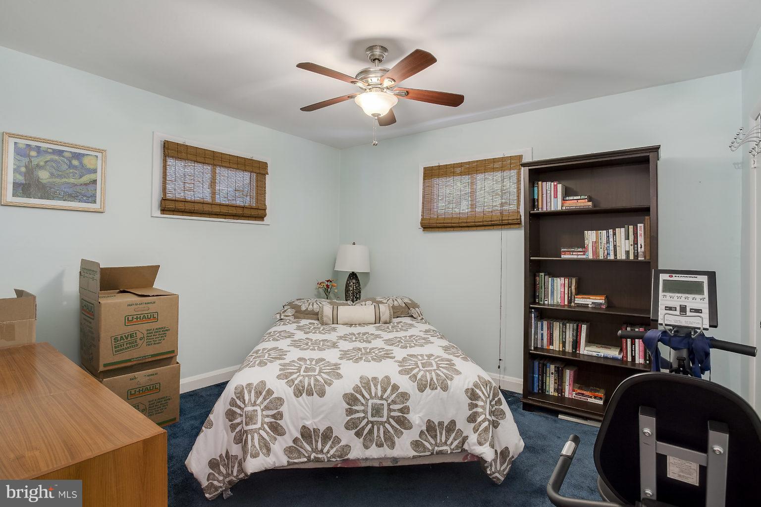 8414 Dogwood Road Baltimore, MD 21244 - Photo 10 of 29 a bedroom with a bed and a bookshelf