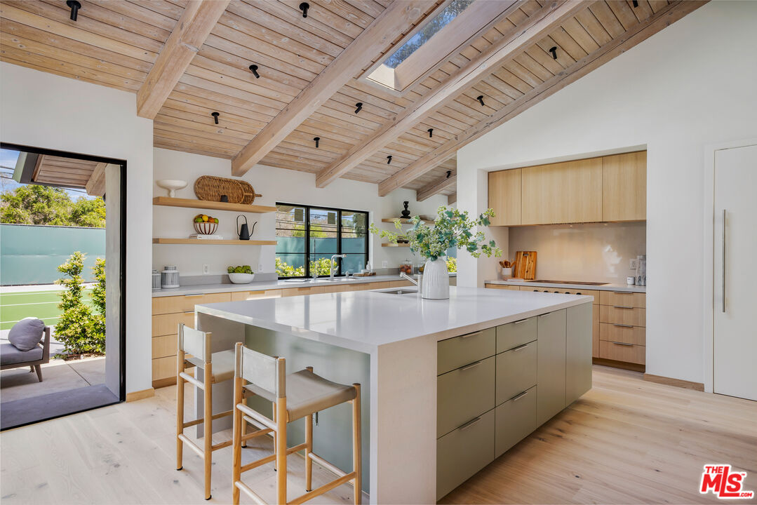 1508 Old Oak Road Los Angeles, CA 90049 - Photo 14 of 63 a kitchen with stainless steel appliances granite countertop a sink and wooden cabinets