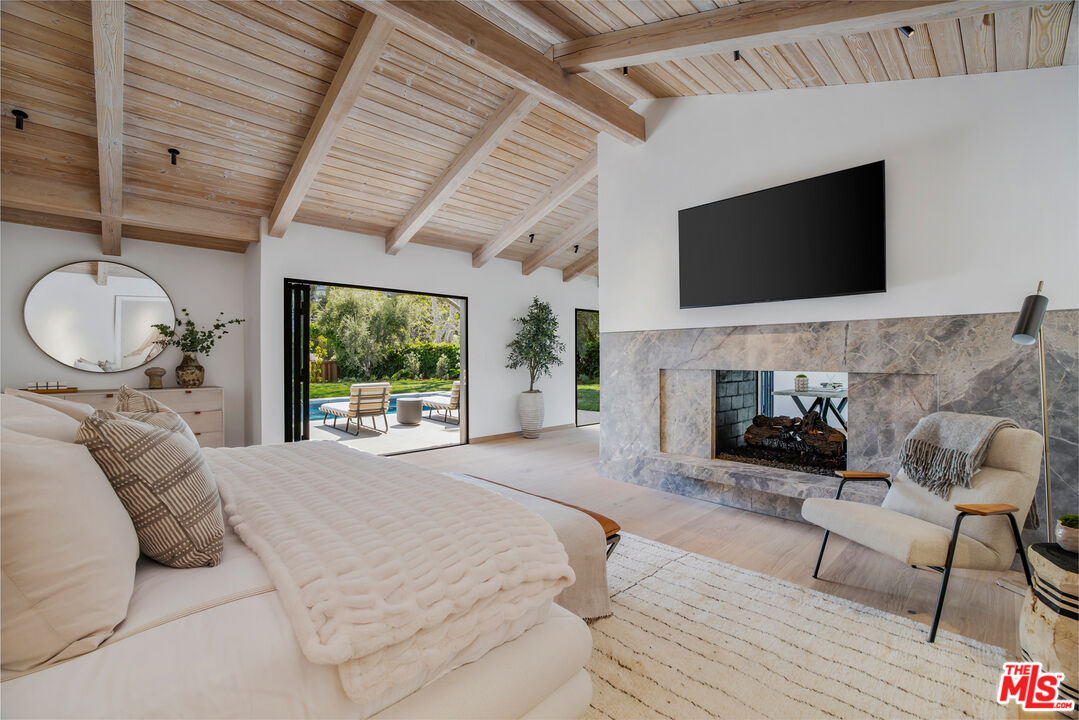 1508 Old Oak Road Los Angeles, CA 90049 - Photo 18 of 63 a bedroom with a bed and a flat screen tv