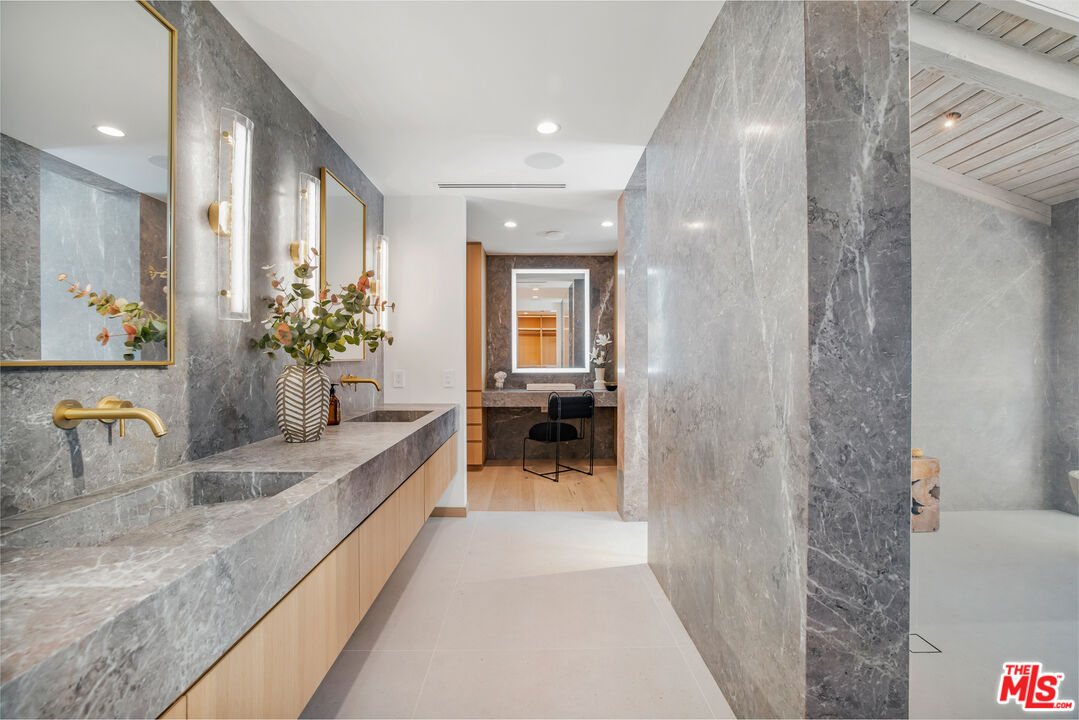1508 Old Oak Road Los Angeles, CA 90049 - Photo 21 of 63 a bathroom with a granite countertop sink and a mirror
